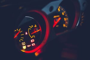 Closeup of oil pressure gauge with arrows and scale on instrument panel in modern auto