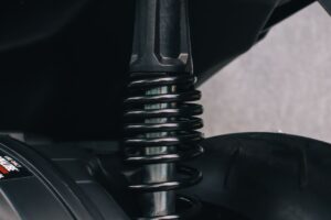 Detailed view of a motorcycle's suspension spring and metal components